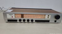 Front view of Goodmans One Ten stereo receiver showing analog tuning dial and control knobs and buttons
