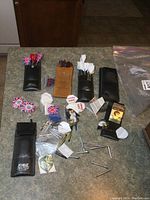 Overall view of darts collection including cases, multiple spare parts, sharpening stones, and accessories