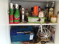 Two white shelves with various household goods including sprays, iron, crafts, and other items