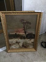 Full image of the framed oil on canvas painting with a natural winter landscape scene and prominent tree in center, set in an ornate gold frame.