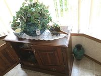 Large green pottery planter with artificial plant and ceramic shell planter on wooden cabinet, green Blue Mountain Pottery vase on floor corner