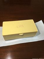 Closed ivory-toned hinged box on tabletop