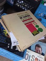 Stack of vintage LP records with 'The Guitar Style of Al Caiola' on top showing cover artwork and condition.