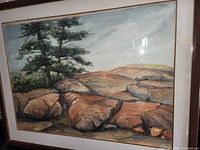 Close-up of the painting showing detailed rocks and tree, highlighting the artwork style and condition.