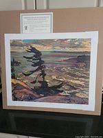 View of the unframed offset plate lithograph 'Stormy Weather' by FH Varley showing the entire image along with a certificate of authenticity above it.