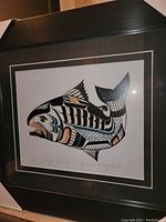 Front view of the professionally framed fine art print of Tyee Salmon by Chief Henry Speck. Image shows the full framed piece, including black wood frame and double mat border.