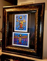 Frontal view of the professionally framed art prints showing clear view of both artworks in ornate wooden frame with gold detailing.