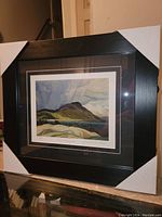 Front view of professionally framed fine art print showing landscape titled 'Lake Wabagishik' by Franklin Carmichael.