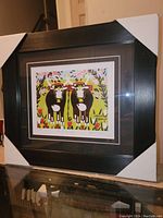 Photo showing the professionally framed fine art print featuring two oxen in a colorful spring setting with protective corner covers on the frame.