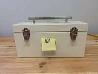 Front view of the white rectangular display decor box with metal handle and silver latches.