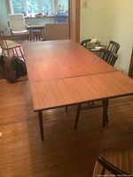 Table with leaves extended into room