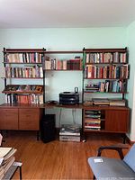 Overall frontal view of assembled wall unit showing base cabinet, shelving sections and contents