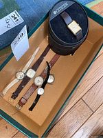 Five watches in a box including Citizen watch in its box.