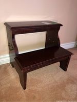 Image of dark brown wooden two-step bed stairs showing front and side profile, visible wear on finish.