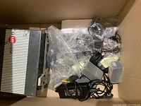 Top-down view of box showing Eumig Mark 8 projector, motor film splicer box, cables and other equipment