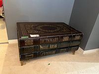 Front view showing three faux book spines labeled Dictionary, World Atlas and Dictionaire