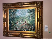 Frontal view of the framed impressionist painting showing ballerinas dancing in a garden with an ornate gold frame.