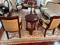 Full view of large rug underneath living room furniture showing overall pattern and condition