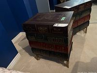 Two book-style side tables together showing overall shape and finish