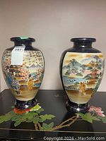 Photo of two Japanese ceramic urns side by side, showing hand-painted traditional scenes and overall shape and size