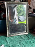 Front view of the rectangular wall mirror with silver frame placed against a wall.