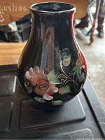 Black ceramic vase with hand-painted pink and green floral design