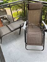 Front and top view of patio chairs on balcony floor showing full design including headrest and armrests.