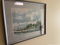 Photo of the entire framed watercolour painting showing the artwork, matte, and silver frame with some damage.