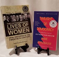 Two books standing on stands showing covers of 'The Extraordinary Lives of Ukrainian-Canadian Women' and 'Twilight of Democracy'