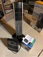 Three heaters together: Bonaire tower heater at back, box labeled 'Bonaire' to the side, and two smaller heaters in front including Likewise heater box visible.