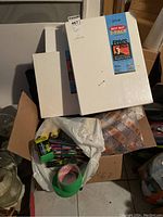 Two unopened white stretched canvases, sizes 12x16 and 12x12 inches, stacked vertically