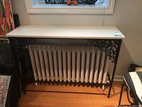 Front view of console table placed over radiator under window