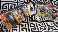 Ten PlayStation 2 game cases laid out showing front covers with titles clearly visible where discernible.