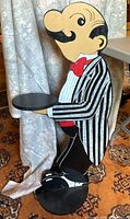 Wooden butler stand shaped like a cartoon waiter holding a small round tray, showing front and side views.