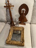 Group photo showing all items: Florentine carved mirror, wooden carved cross with girl praying, carved wooden Mary statue, and apothecary jar with stopper.