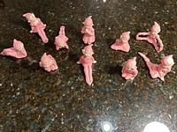 Top-down group shot showing all 10 pink pixie elf figurines on countertop