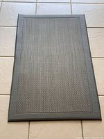 Top view of the grey rectangular anti-fatigue mat showing textured surface for comfort and traction.