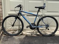 Full side profile of the bicycle showing frame, wheels, tires, seat, pedals and handlebars.