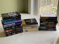 Three stacks of novels with titles visible including Karin Slaughter books and others