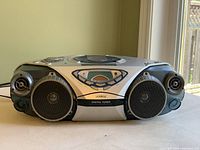 Front view of portable Philips stereo showing dual round speakers and digital tuner display