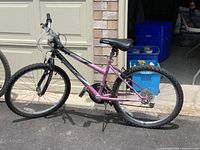 Full side profile of the Supercycle SC1800 bicycle showing black and purple frame with knobby tires and saddle.