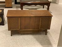 Full frontal view of the Lane vintage cedar chest, closed, showing Dunstock Walnut finish and wicker style front side panels.