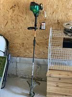 Full view of the Weedeater FeatherLite string trimmer showing overall length and design.