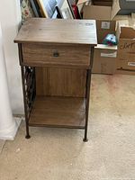 Front and side view of the wooden top cabinet with metal frame and a drawer, showing general condition and structure.