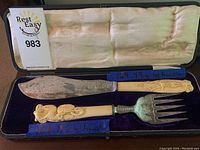 Opened box showing both utensils in fitted velvet lining