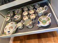 Drawer with green and gold floral Paragon fine bone china pieces including teapot, sugar bowl, creamer, gravy boat, serving plates, teacups, saucers