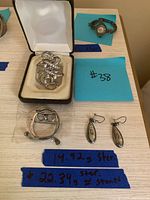 Overview photo of all sterling silver jewelry items on a table with weight notes
