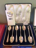 Six sterling silver spoons displayed in original case lined with black velvet and white satin.