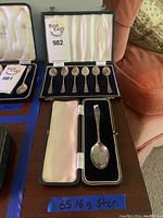 Single larger sterling silver serving spoon in a separate box with satin interior and labeled weight of 65.16 grams.