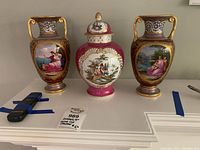 Front view of two vases and lidded urn on shelf